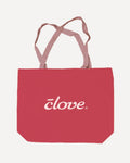 A red canvas tote bag with dusty pink handles and a white 'clove' logo printed on the front, shown against a light off-white background.