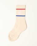 A single cream-colored ribbed sock with a white embroidered 'C' logo, a thin red stripe, and a blue stripe on the ribbed cuff, shown against a plain off-white background.
