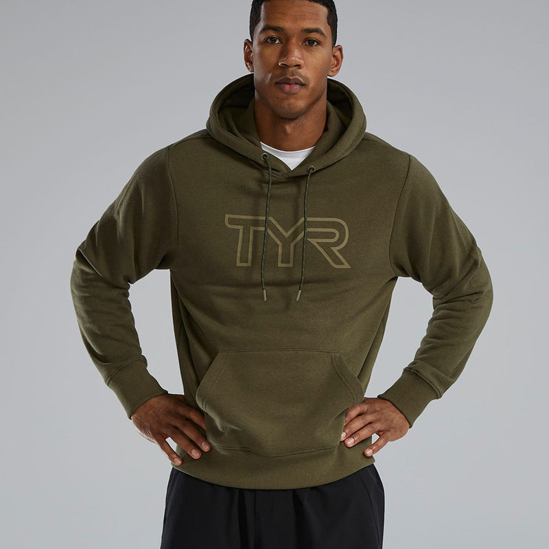 Man wearing a green TYR hoodie against a gray background